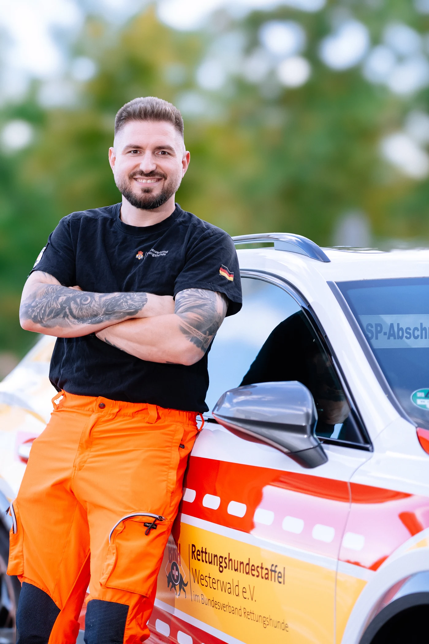 Marcel Schäfer vor dem Fahrzeug der Rettungshundestaffel Westerwald